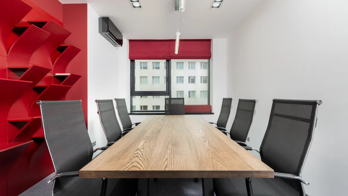 Empty office meeting room with a long table, illustrating cybersecurity for financial advisers