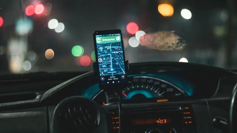 Driver device management: a smartphone in a dashboard mount inside a vehicle cab at night