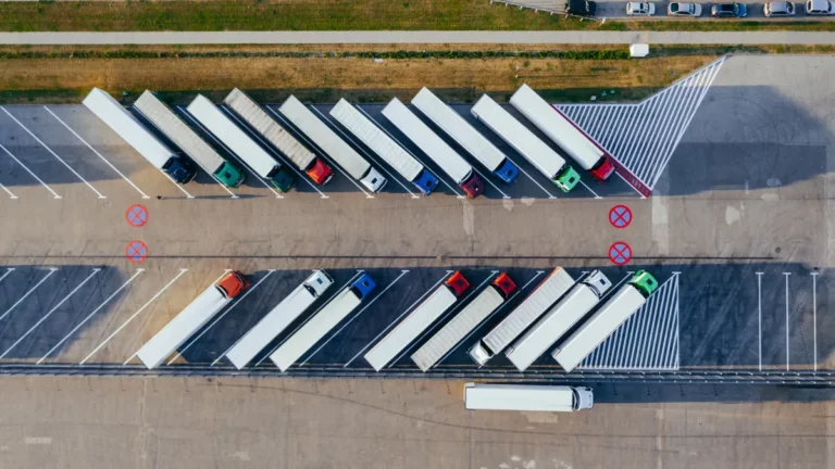 Aerial view of lorries parked in a depot yard, illustrating IT support for haulage companies